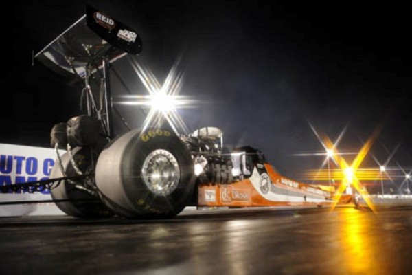 top fuel drag car at night on strip