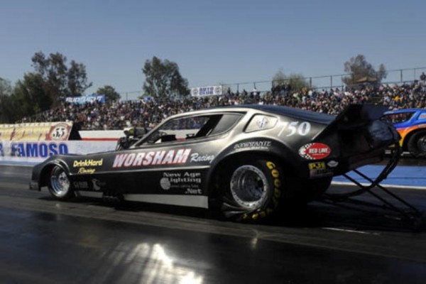 vintage camaro funny car launching at dragstrip