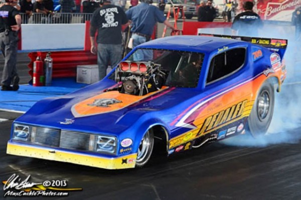 vintage nostalgia funny car doing a burnout at the track