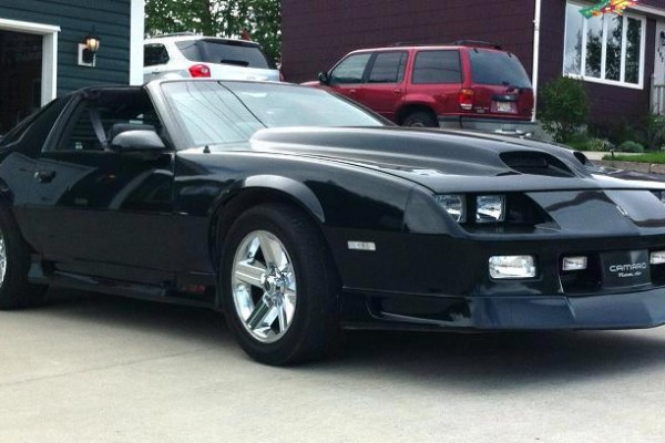black 1991 Chevy Camaro Z28 with a custom hood