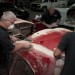 men applying filler and sanding bodywork on a cobra kit car thumbnail