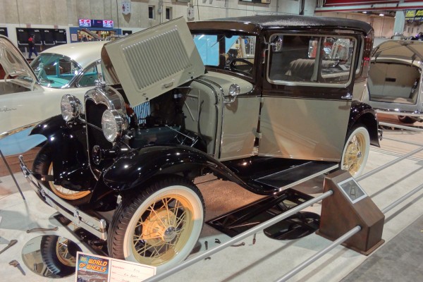 restored ford tudor coupe at a car show