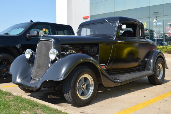 vintage ford hot rod coupe in a parking lot