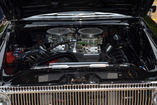 426 hemi v8 engine with cross ram intake in an old mopar