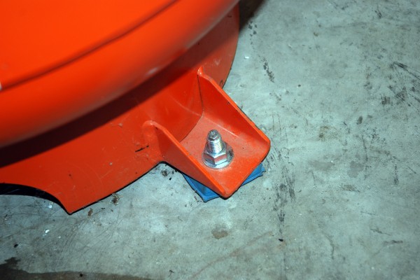 floor anchors bolted to a shop air compressor