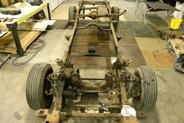 bare truck frame in restoration shop