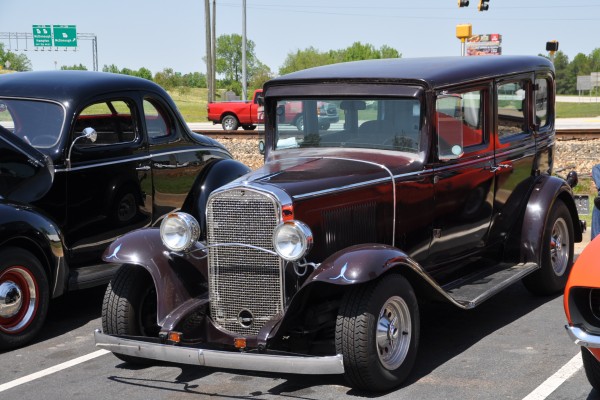 vintage hot rod sedan at a car show