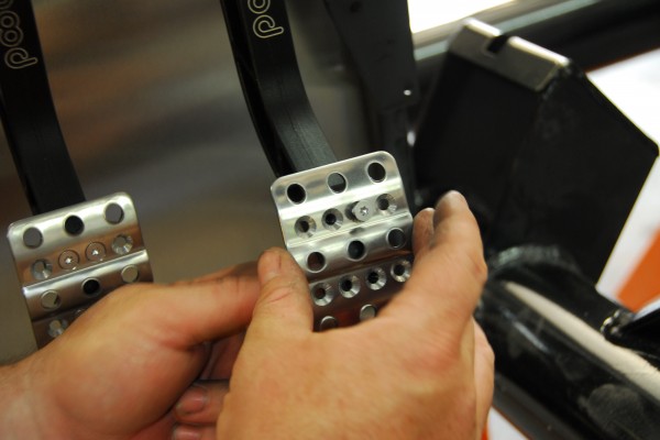 Aluminum pedal pads getting installed in a car