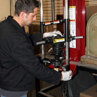 compressing a vehicle coil spring