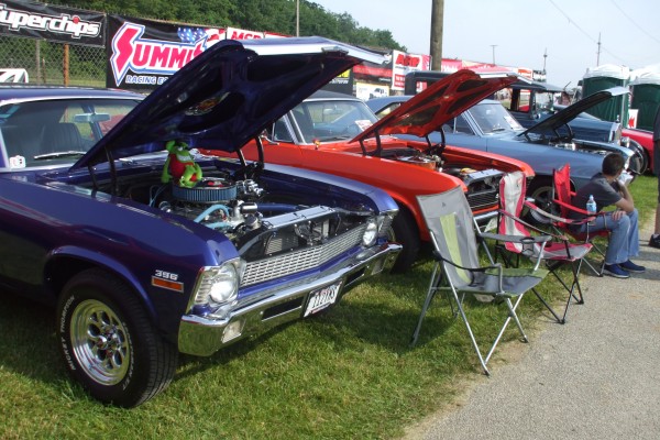 row of muscle cars at a large show