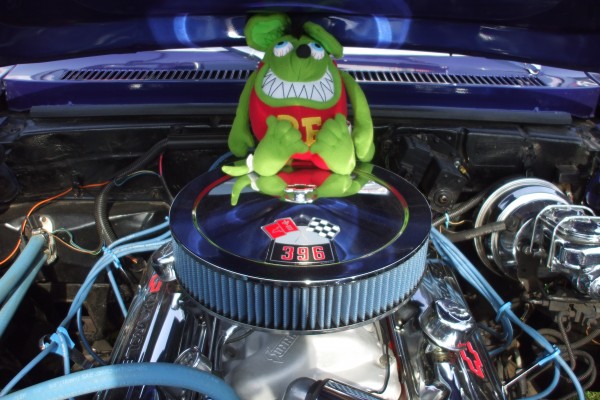 Rat fink doll atop a big block chevy 396 in a muscle car
