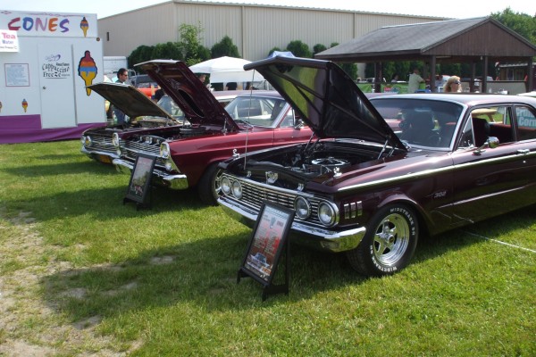 row of classic cars at a car show