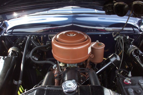 vintage ford motor in an old shoebox coupe