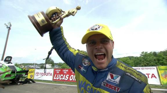 Shawn Langdon celebrates nhra win with wally trophy