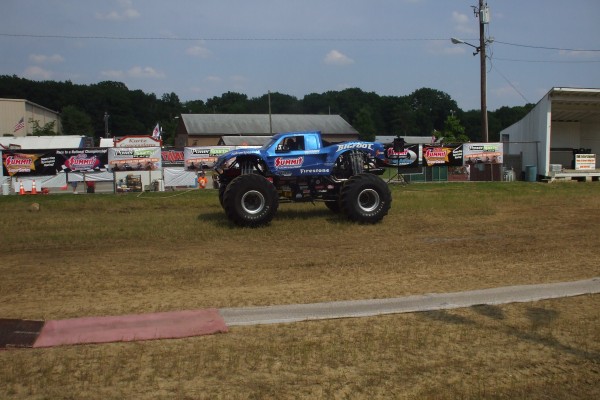 bigfoot monster truck driving on a grassy field