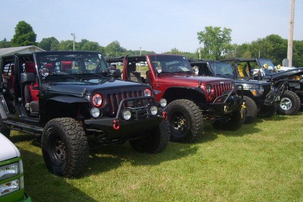 row of jeep wranglers at a car show