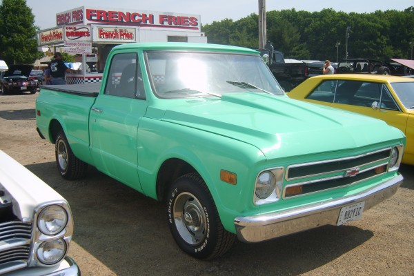 customized chevy c10 truck at a car show
