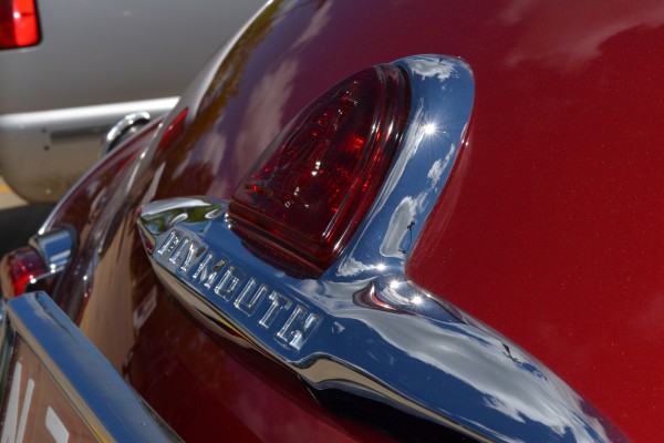 ship and trunk emblem on a 1947 plymouth hot rod coupe