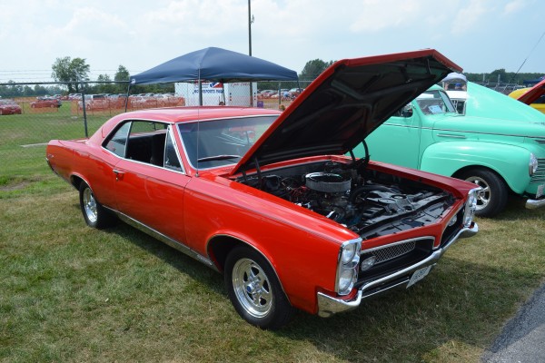1967 red pontiac gto coupe with custom wheels
