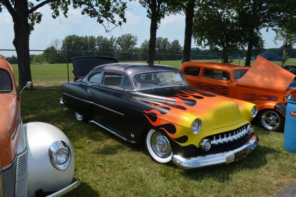 flamed postwar hotrod coupe at a car show