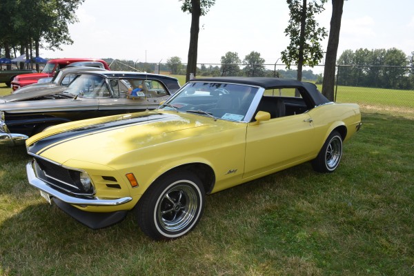 yellow ford mustang convertible at car show