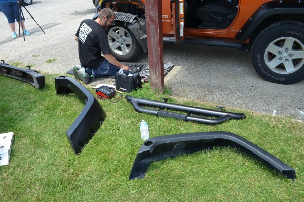 bolt-on jeep parts resting on grass