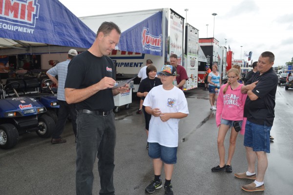 nhra pro sock drag racer Jason Line signing an autograph