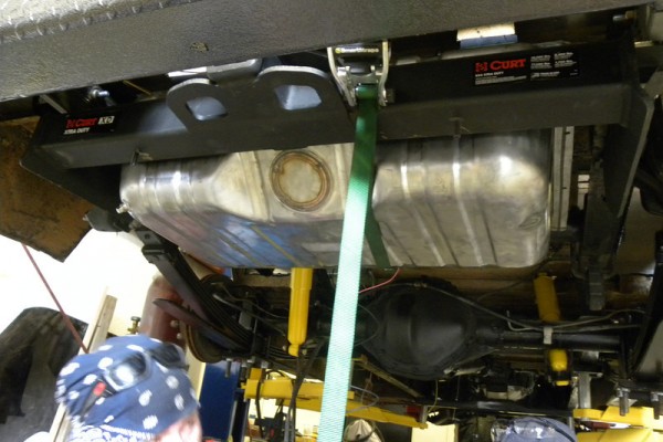 gas tank getting installed in a hot rodded 1949 chevy kurbmaster step van