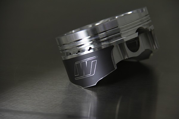 wiseco piston head on a metal table