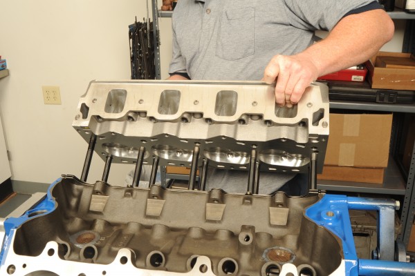 man installing trick flow cylinder head onto a big block chevy engine