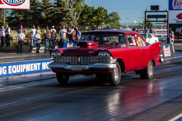 vintage plymouth fury drag car launching at dragstrip