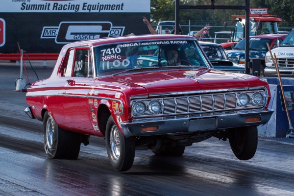 mopar drag car launching at drag strip
