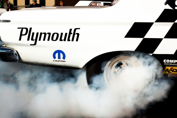 close up of a wheel during a burnout at a drag strip