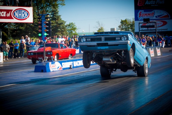 vintage mopar doing massive wheelstand at a drag race