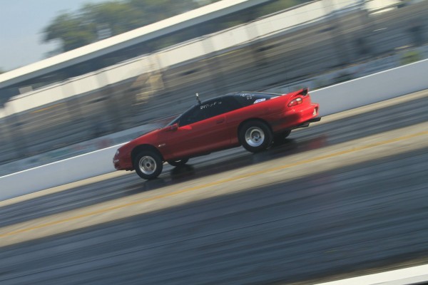fourth gen chevy camaro running down dragstrip track