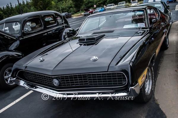 black Ford Torino GT with shaker hood