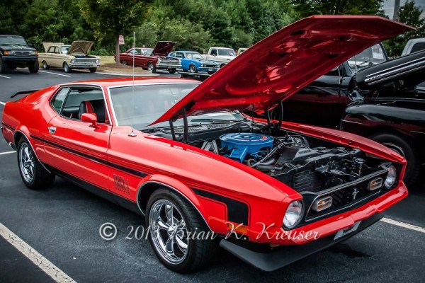 orange and black ford mustang mach 1 with hockey stick stripe
