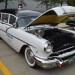 vintage 1956 Pontiac hearse in funeral home livery at a car show thumbnail