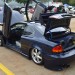 customized olds alero with scissor doors at a car show thumbnail