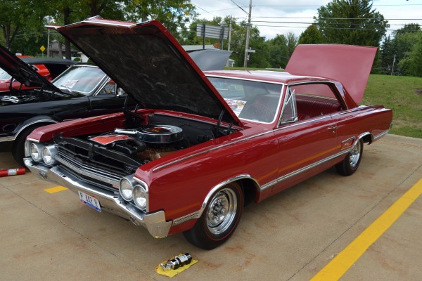 red Oldsmobile cutlass hardtop coupe