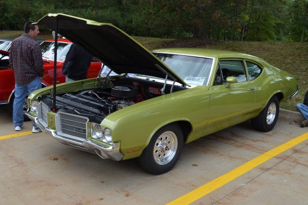 green oldsmobile cutlass fastback post coupe with custom wheels