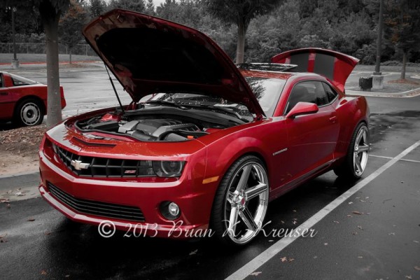 Red 5th-gen chevy camaro with oversized custom wheels