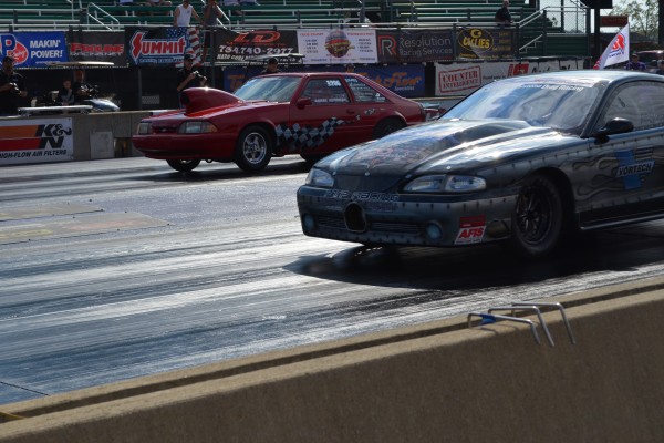 a pair of drag race cars staging before a drag race