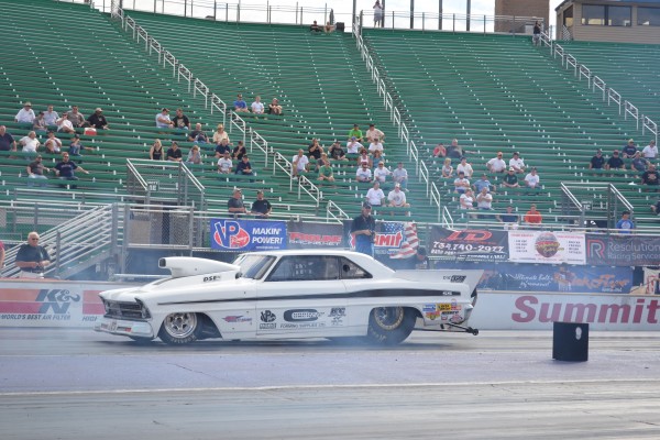 a vintage musclecar drag car at a race track