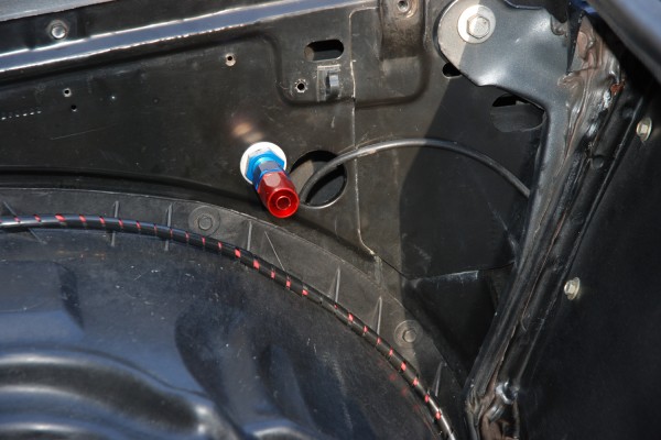 Fuel line bulkhead fitting on a classic car