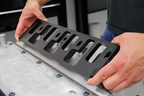 intake spacers being placed onto a cylinder head