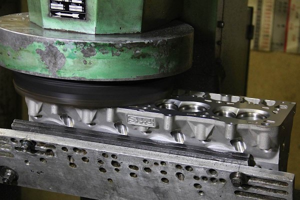 machine decking a set of engine cylinder heads