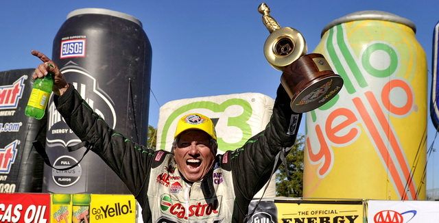 john force lifting nhra wally trophy in celebration