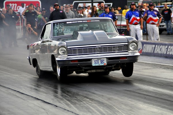 a chevy 2 nova drag race doing a wheelstand at launch