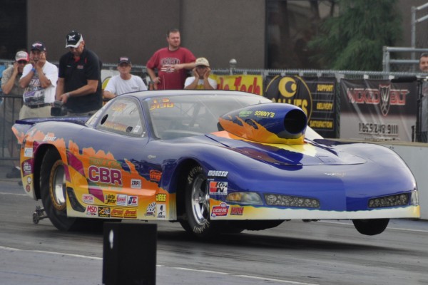 fiberglass bodied c5 corvette drag car launching at a race